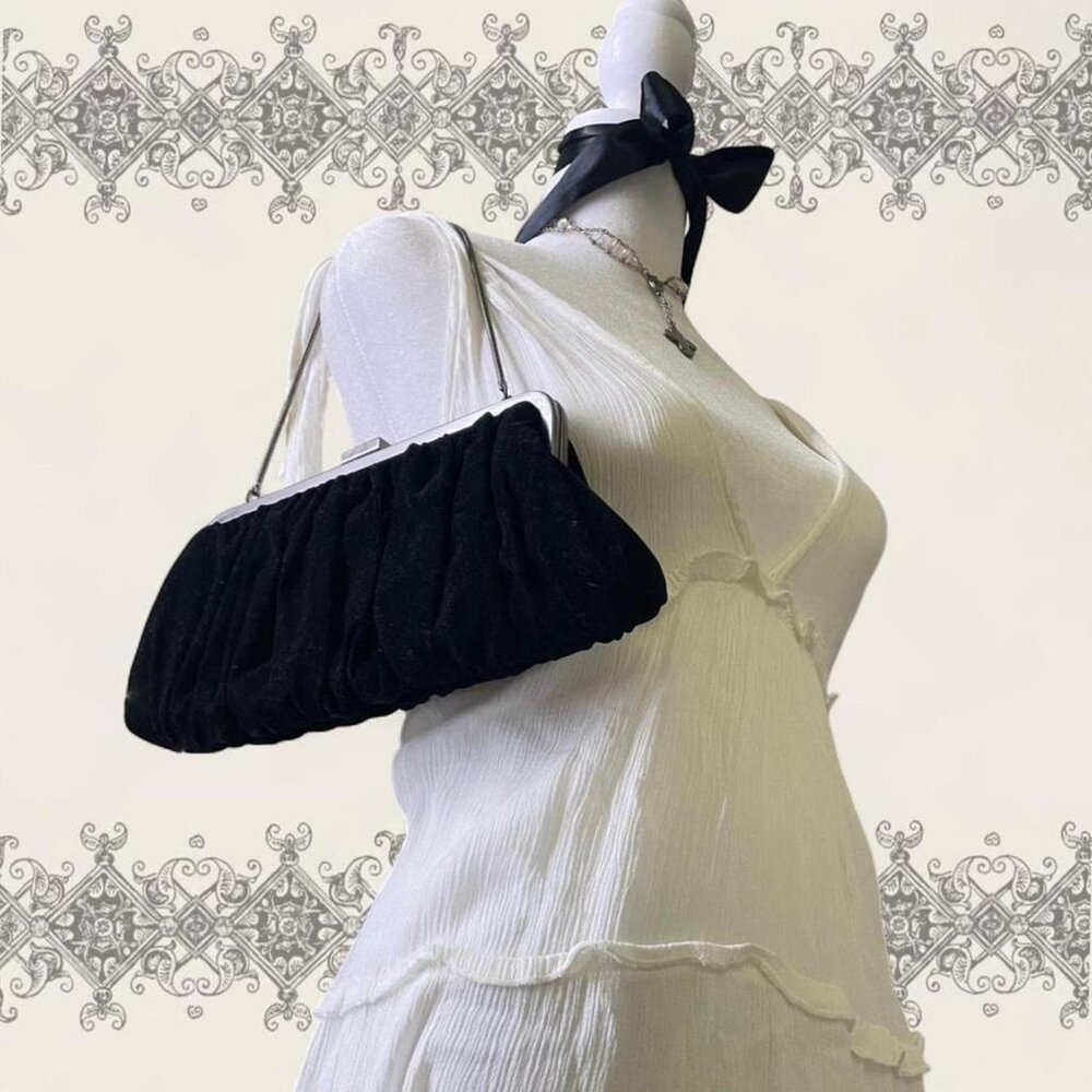 Black velvet clutch purse with pink interior and chain